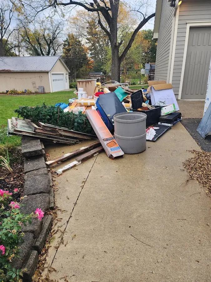 Dumpster being loaded with debris for Estate Cleanout Dumpster Rental in Lake Worth Beach